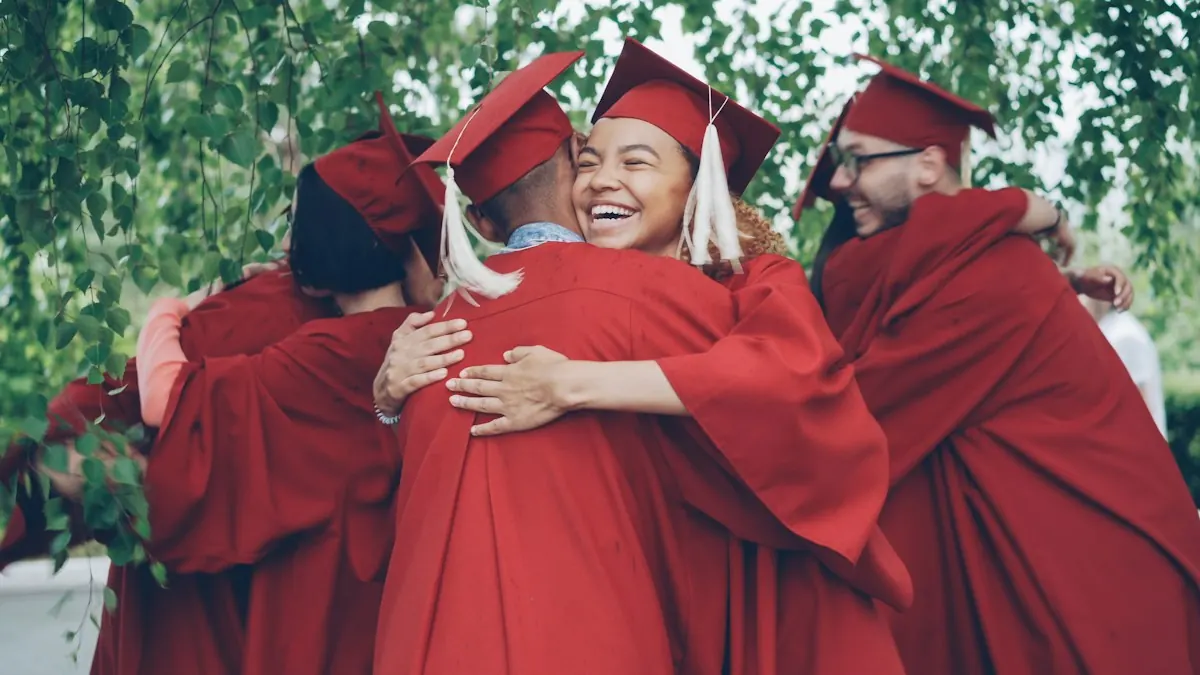 Graduates in gowns hugging and celebrating